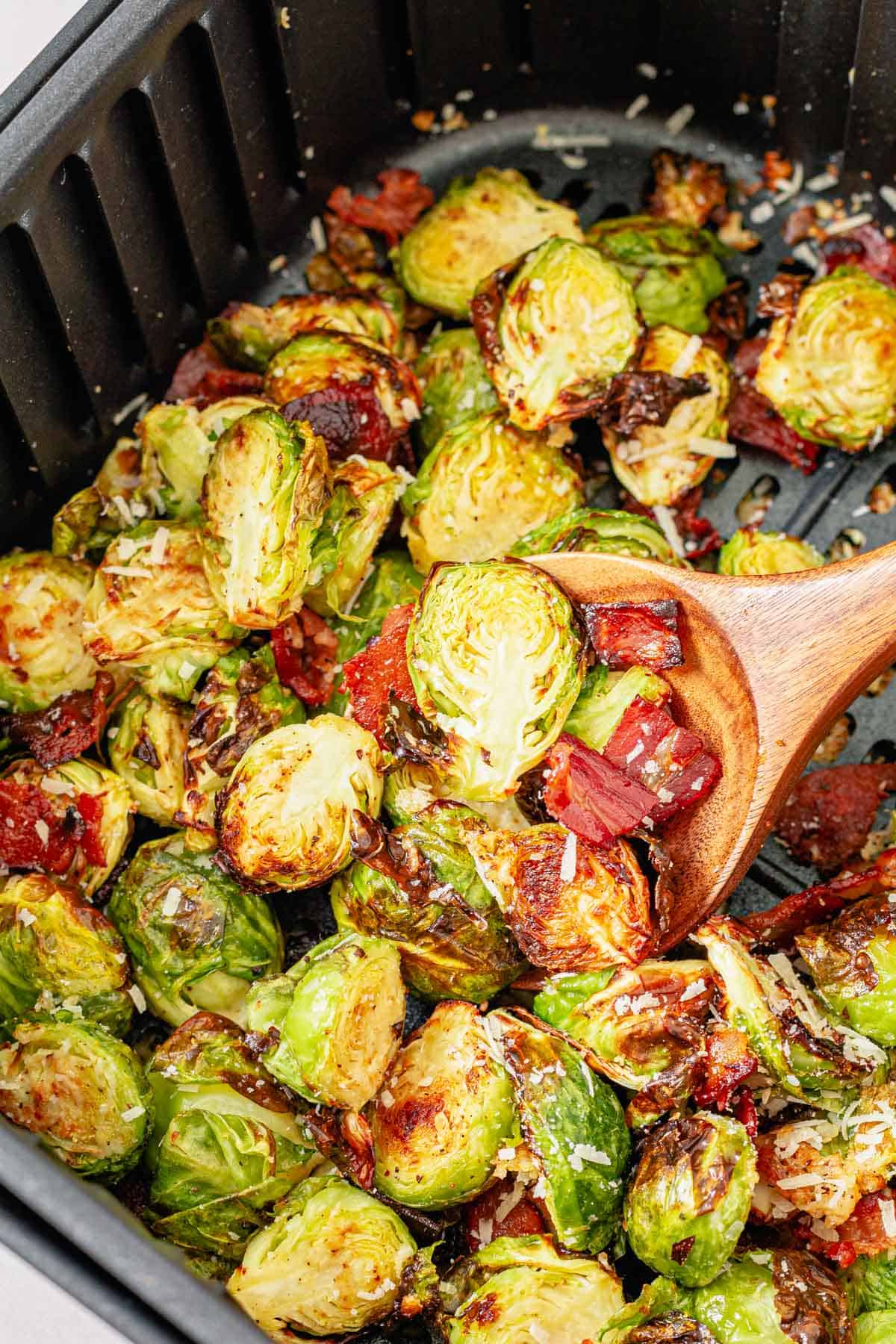wooden spoon in cooked brussel sprouts basket
