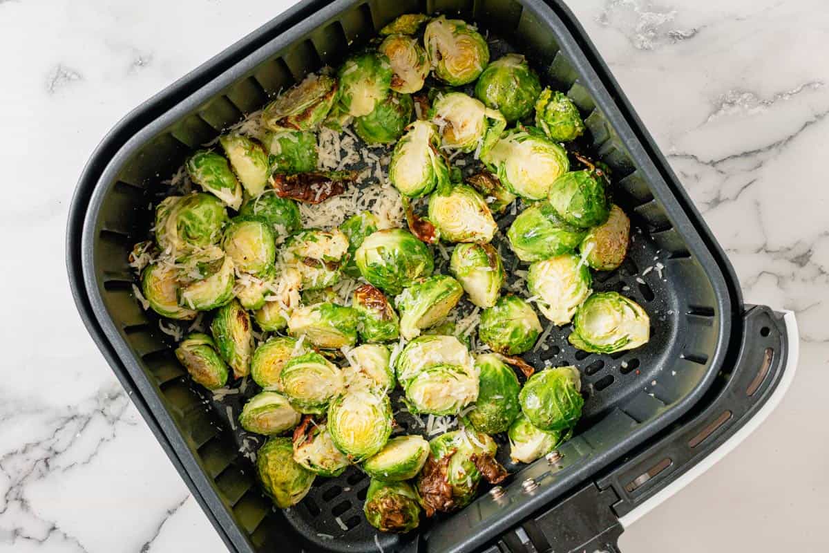 fresh brussel sprouts in an air fryer basket