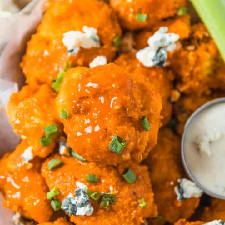 Buffalo Cauliflower Bites with blue cheese crumbles and sauce