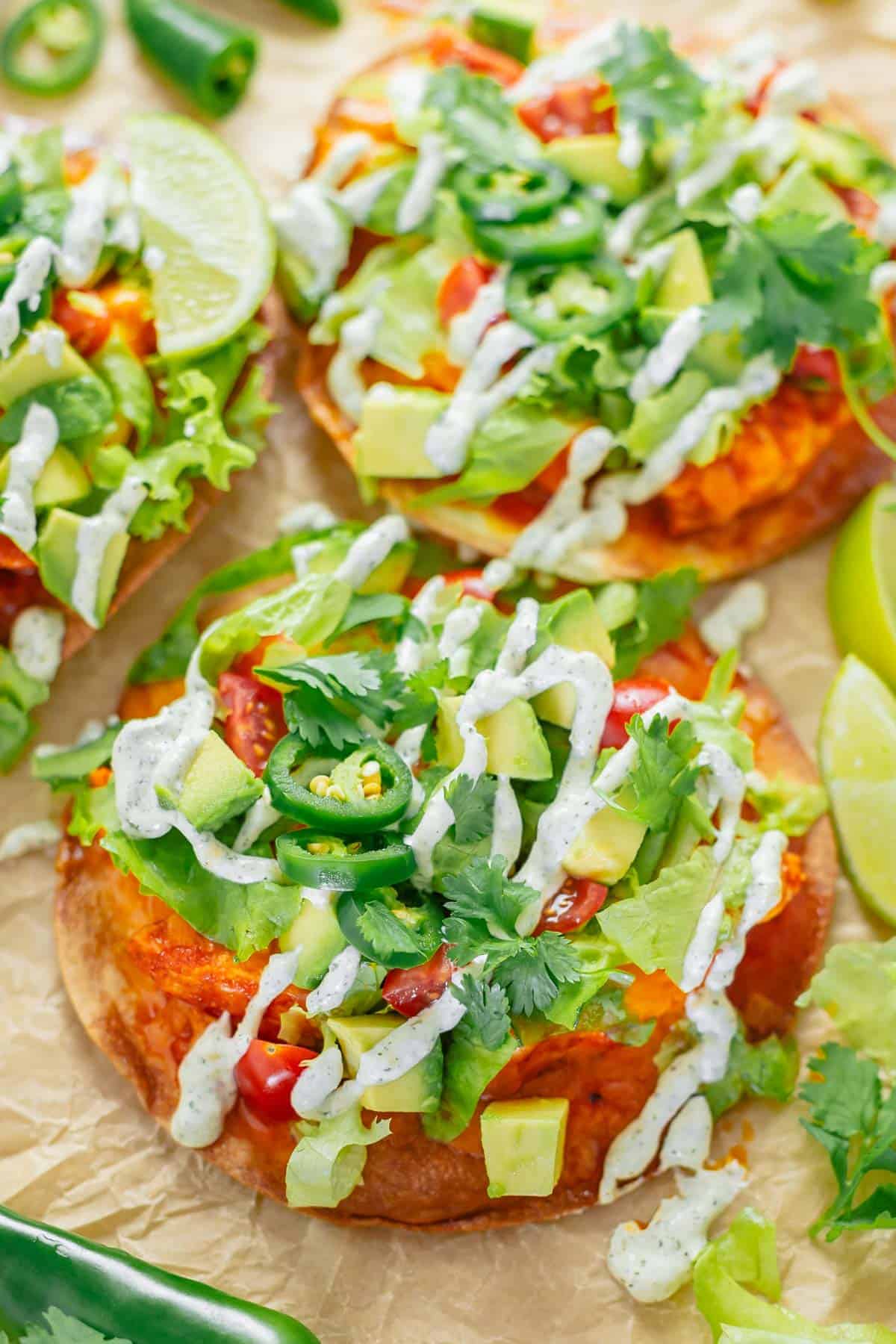 crispy tostadas with buffalo chicken toppings and ranch dressing close up shot