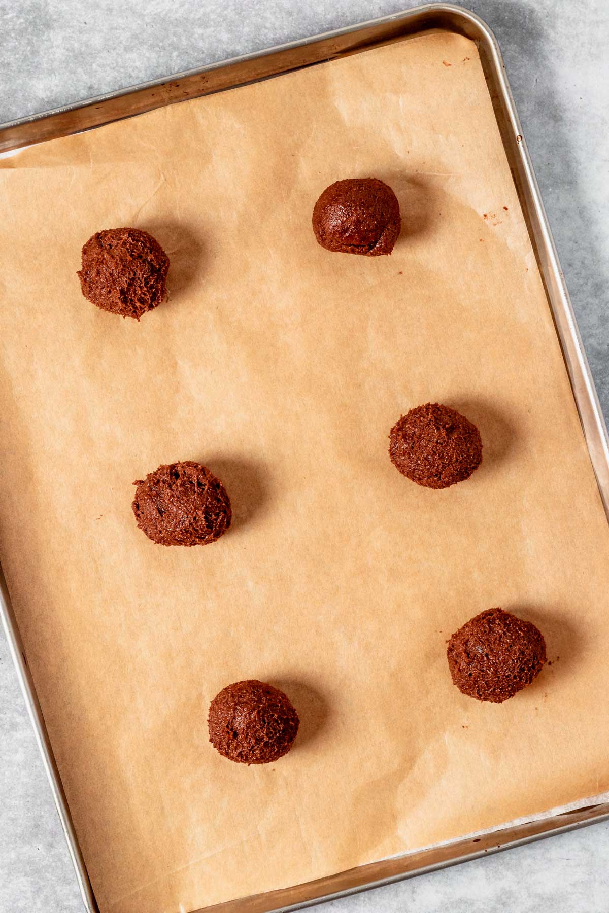 gluten free chocolate chip cookie dough balls on a baking sheet