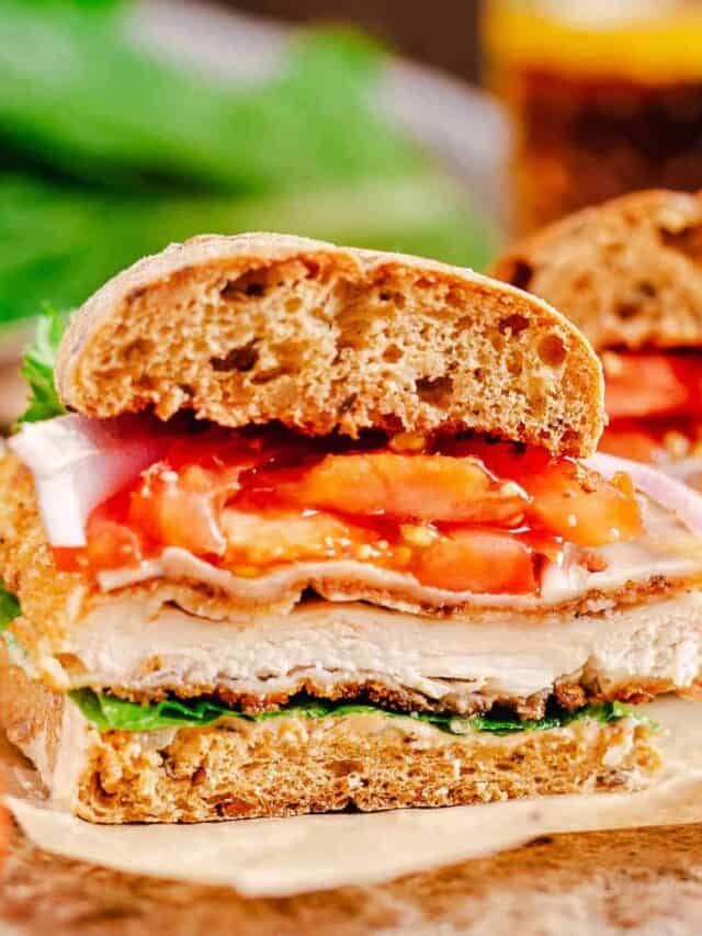 chicken ciabatta sandwich cut out shot over dark background