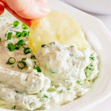 chips dunked into creamy cold spinach dip
