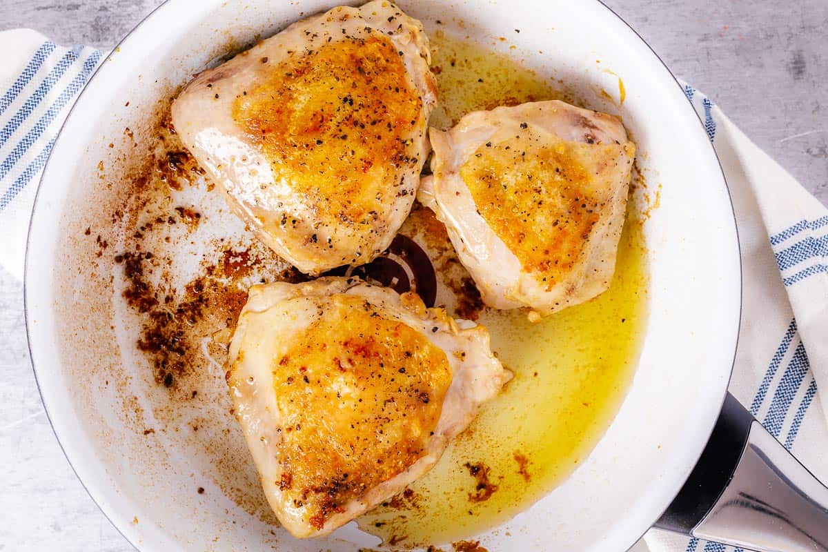 cook the chicken thighs in a skillet until crispy and golden brown