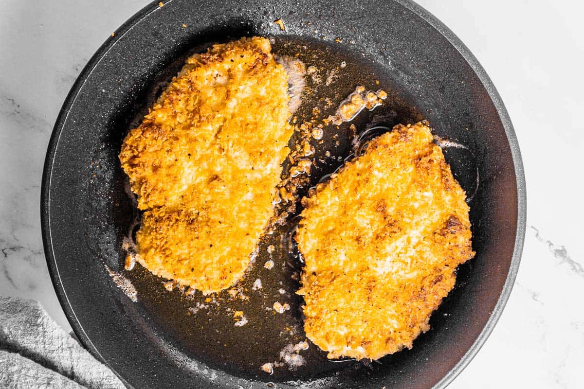 crispy panko chicken frying in pan