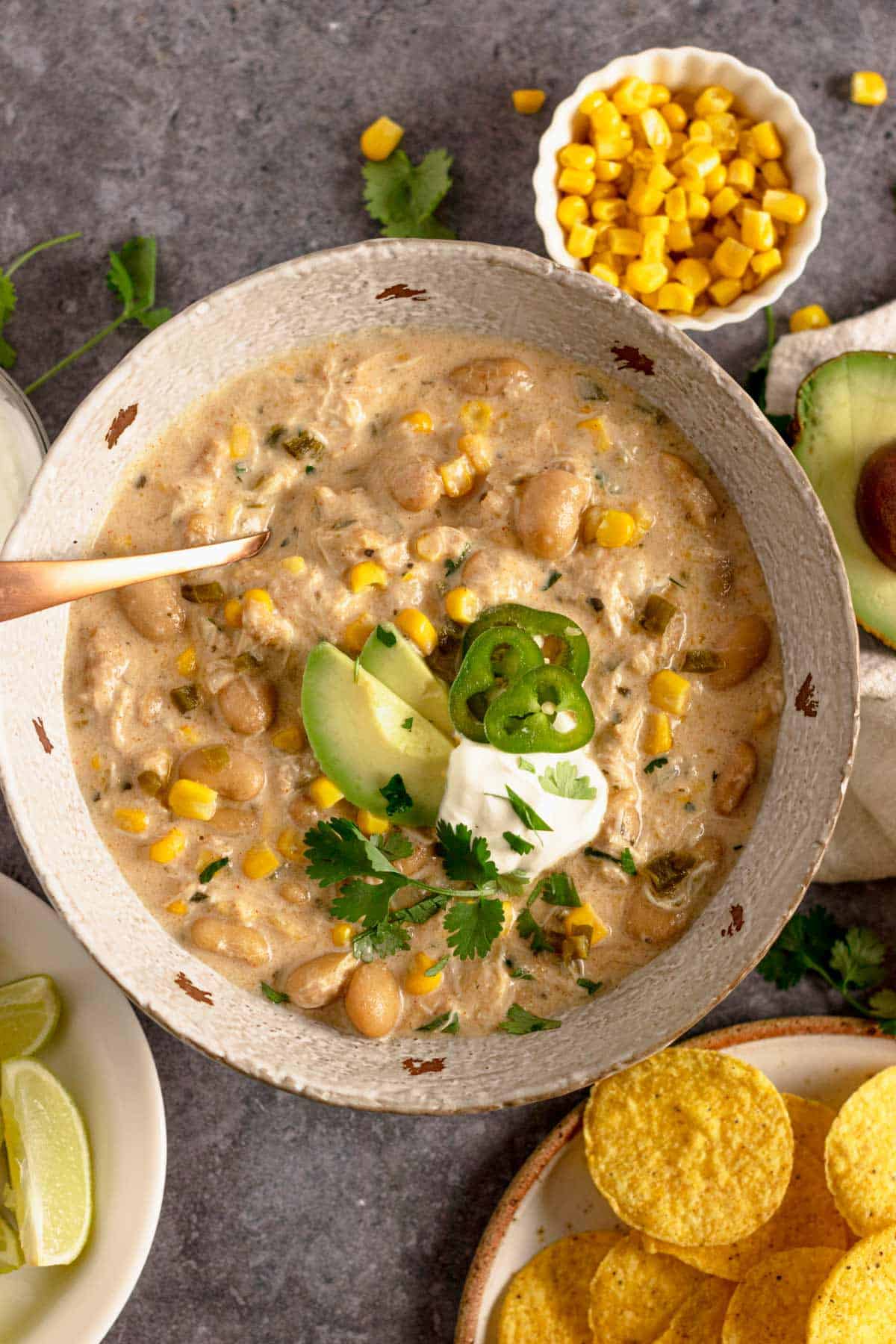 Crock Pot Chicken Chili Cream Cheese with doritos and cilantro, avocado