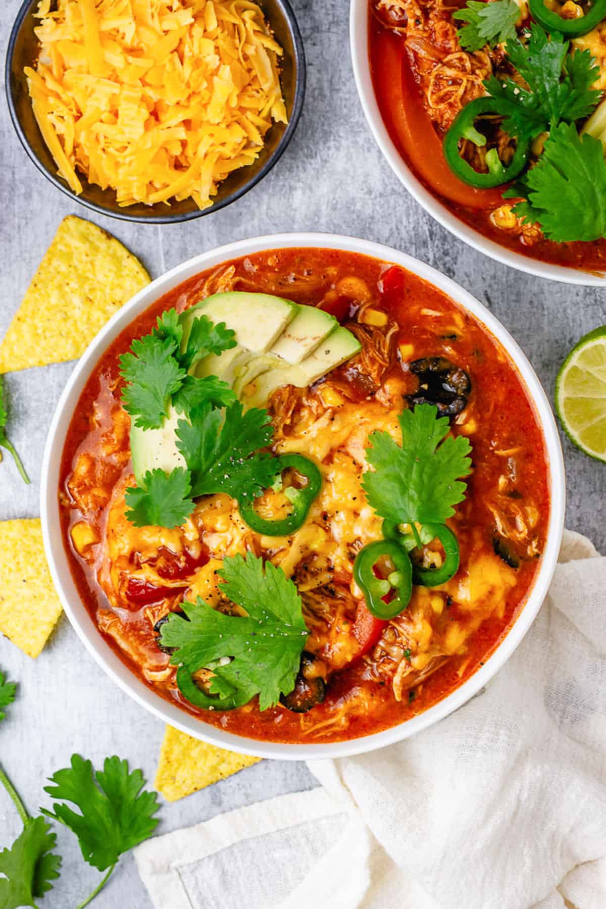 chicken enchilada in a bowl with avocado jalapeno tortilla chips