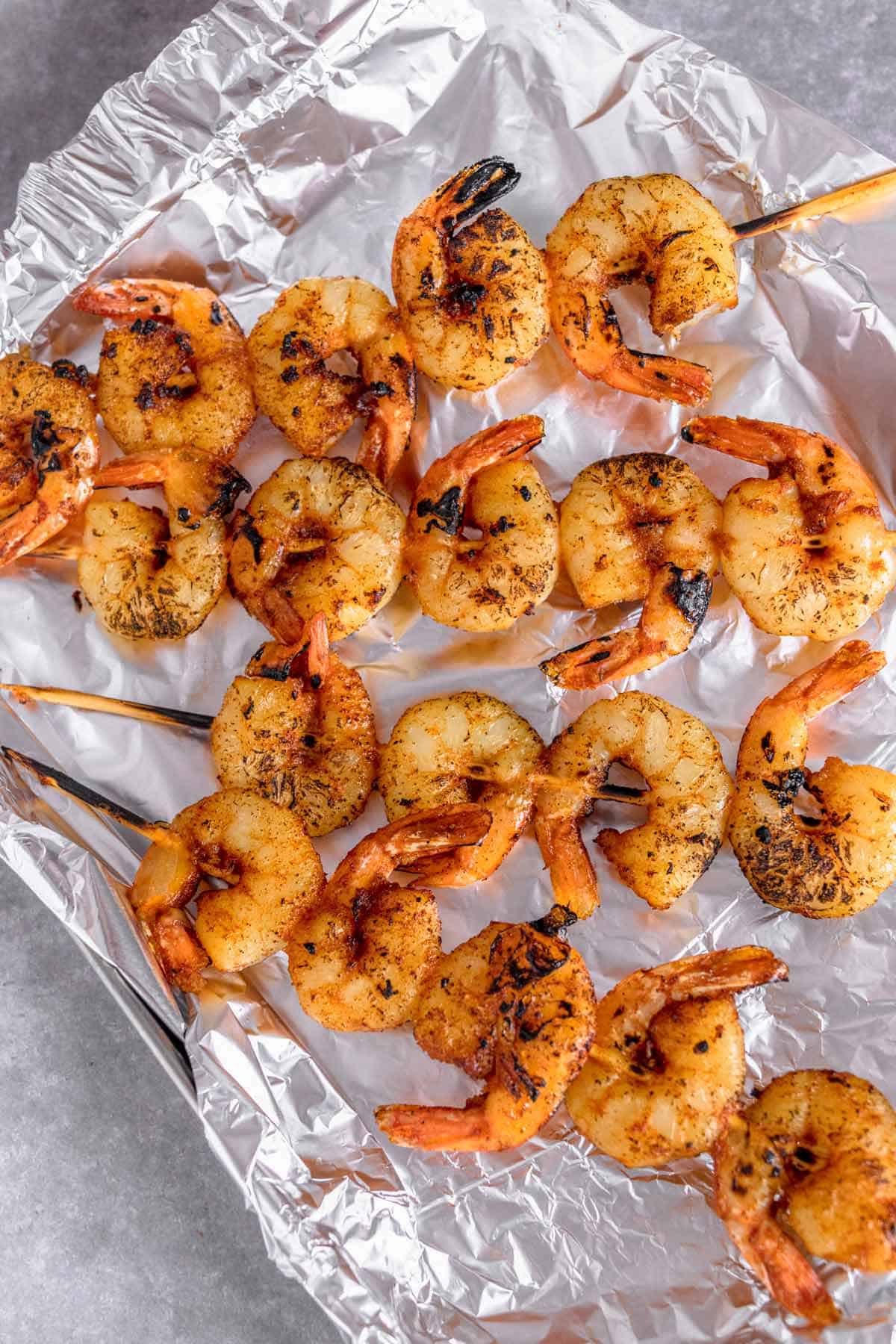 grilled shrimp skewers on a baking sheet