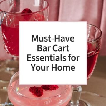 Three elegant glasses filled with pink berry cocktails or mocktails, garnished with raspberries and served on a table, creating a festive summer entertaining atmosphere.