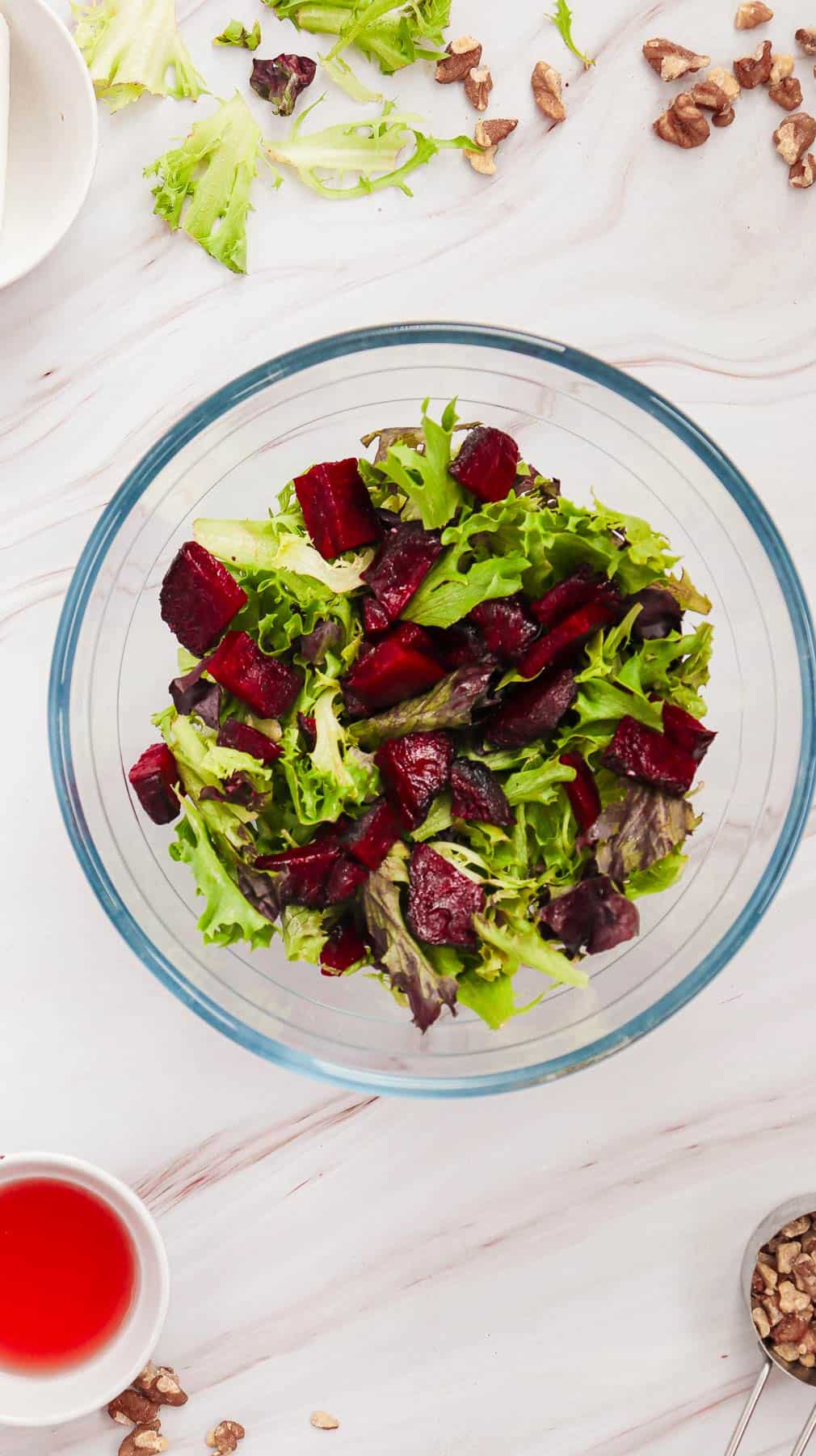 beets and salad greens in a bowl.