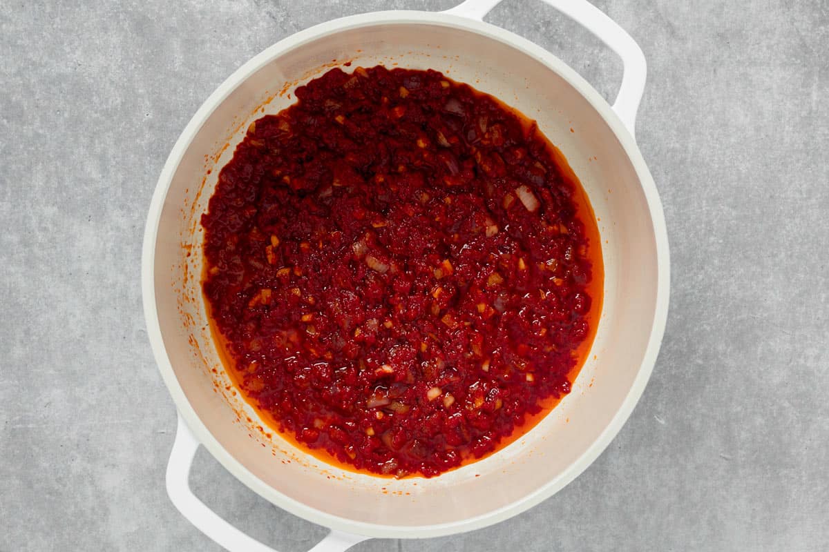 tomato paste and onion cooking in a pot