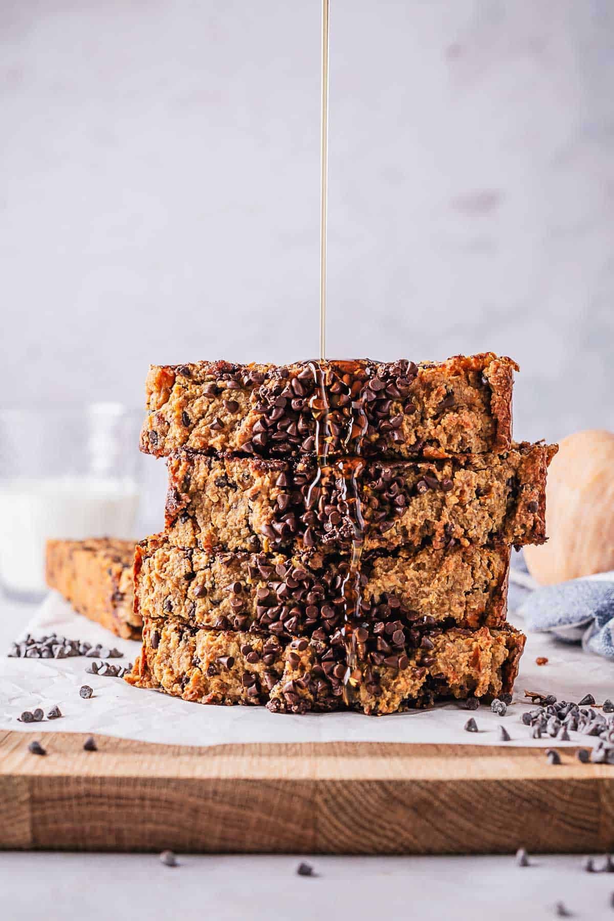 maple syrup drizzled on top of stack of pumpkin bread