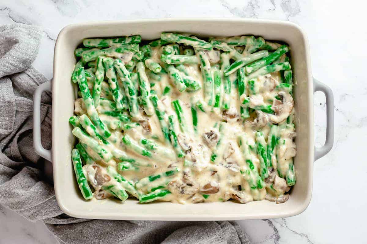 Creamy mushroom sauce with green beans in baking dish