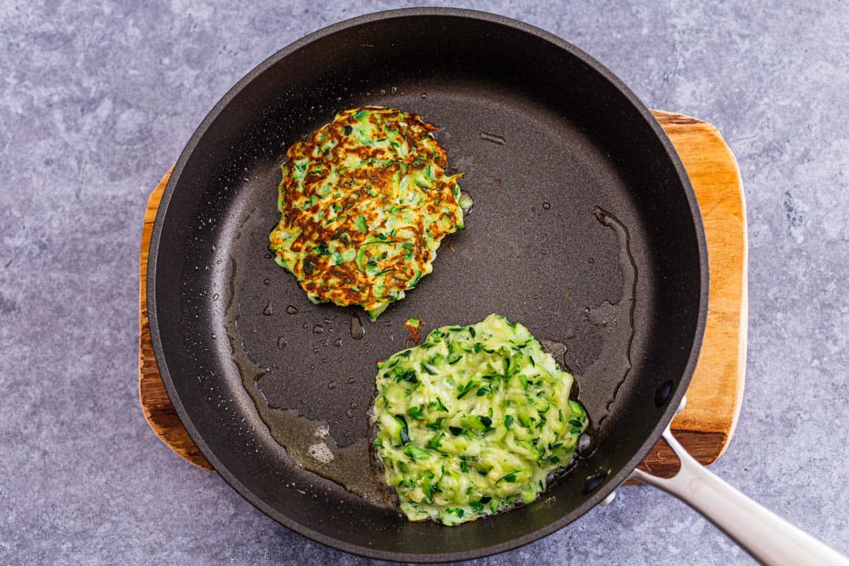 zucchini fritters fried on a pan