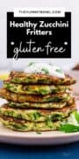 stack of zucchini fritters with a dollop of sour cream and parsley