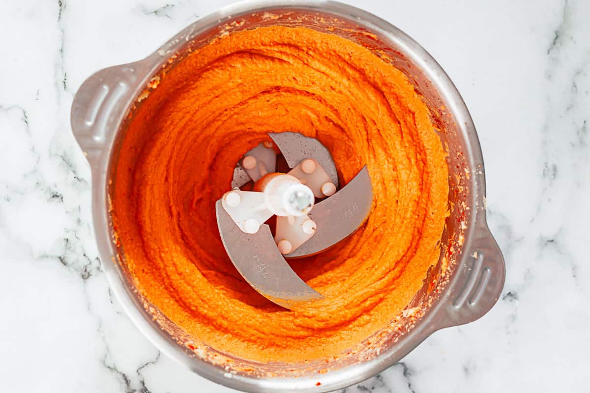 roasted pepper hummus in a bowl of a food processor