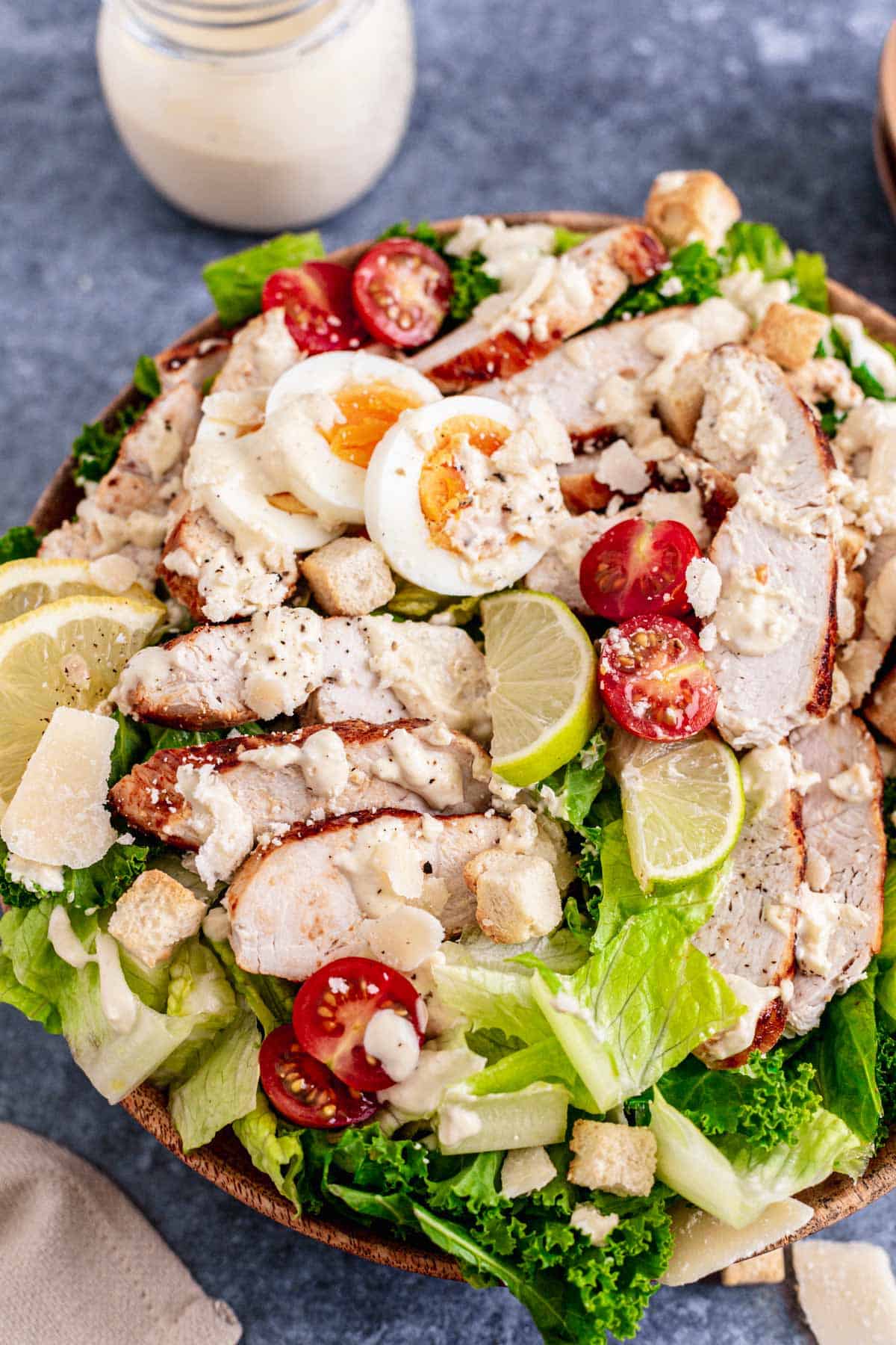 Lemon Kale Caesar Salad with chicken in a white bowl