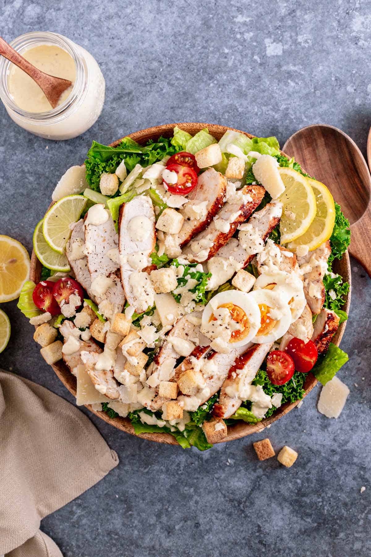 Lemon Kale Caesar Salad with chicken in a white bowl