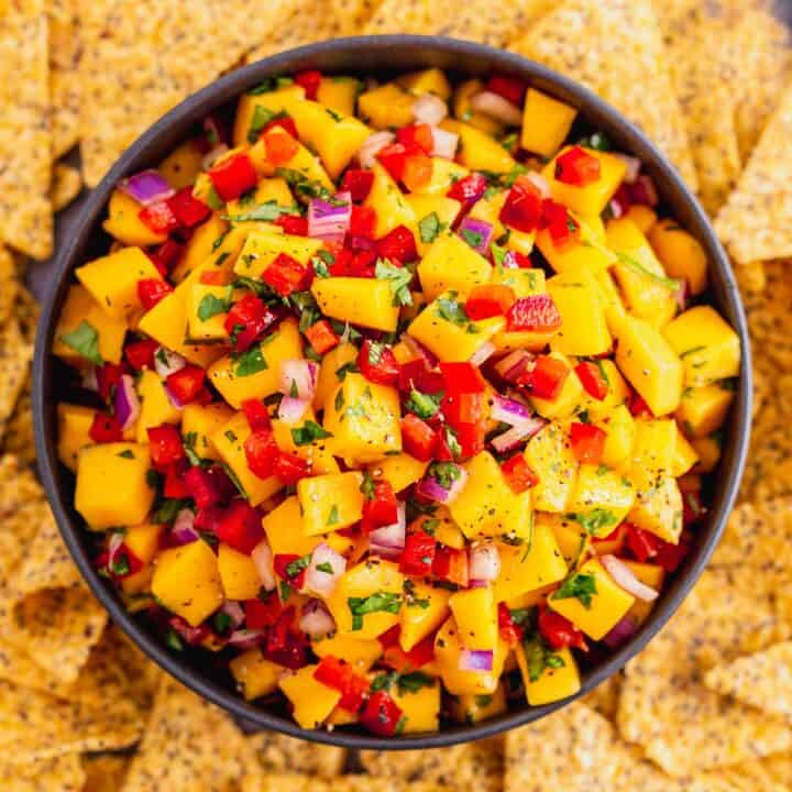 mango salsa with spicy peppers in white bowl