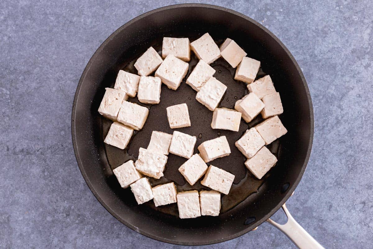 tofu cubes in a nonstick pan