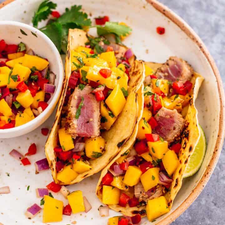 ahi tuna tacos with mango salsa on a wooden board