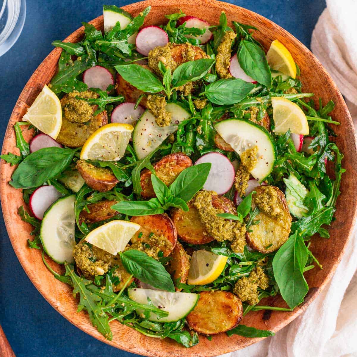 pesto potato salad in a wooden bowl