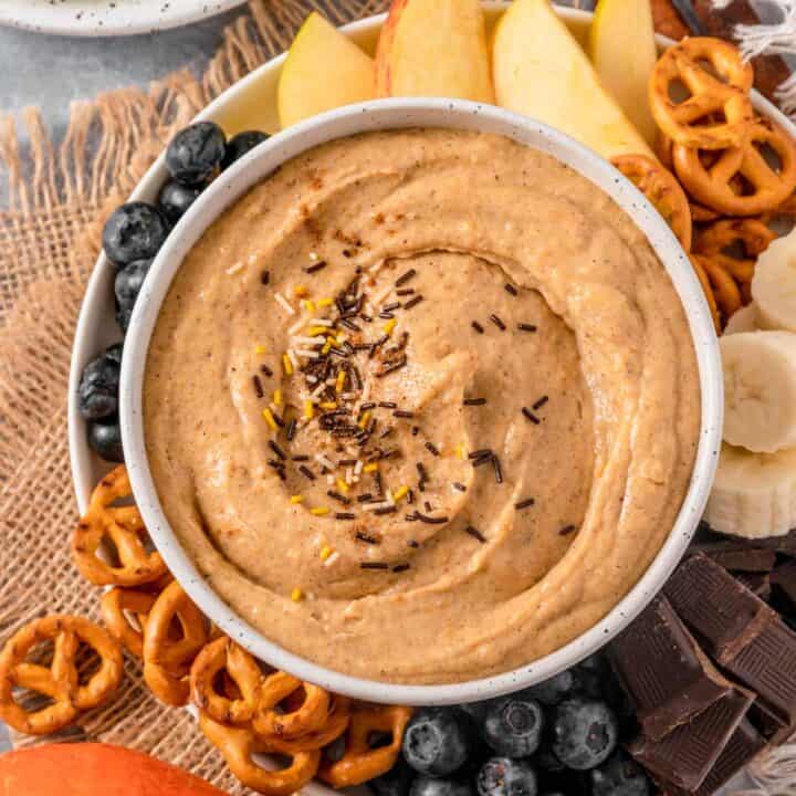 Pumpkin Cream Cheese Dip with pretzels, banana, chocolate, blueberries and apples