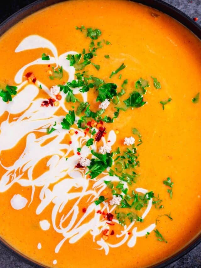 vegan pumpkin soup with cilantro and sour cream in a bowl