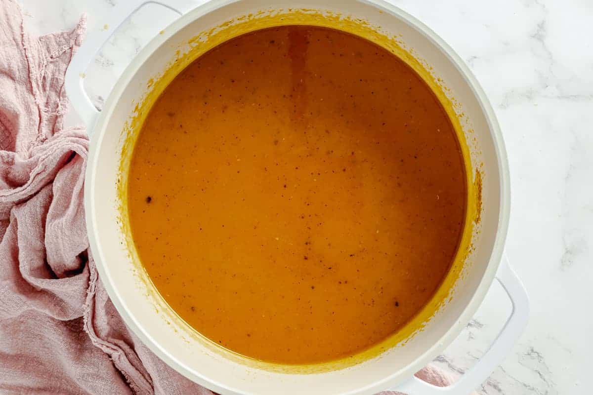 pumpkin caramel simmering in a white large pot
