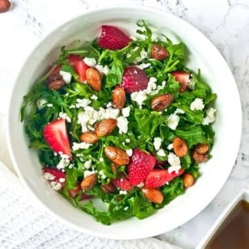 This Strawberry Arugula Salad with Caramelized Almonds is one of my favorite salads to make. It’s easy, flavorful and great for side dishes or served with grilled chicken as a wholesome dinner. Top it up with a light olive oil based salad dressing for a perfect finish. - The Yummy Bowl