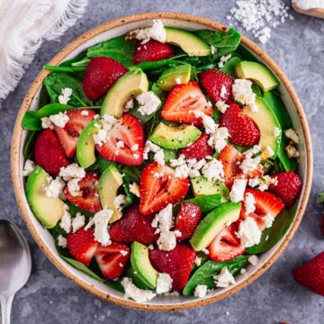 Spinach Strawberry Salad With Feta in a white bowl
