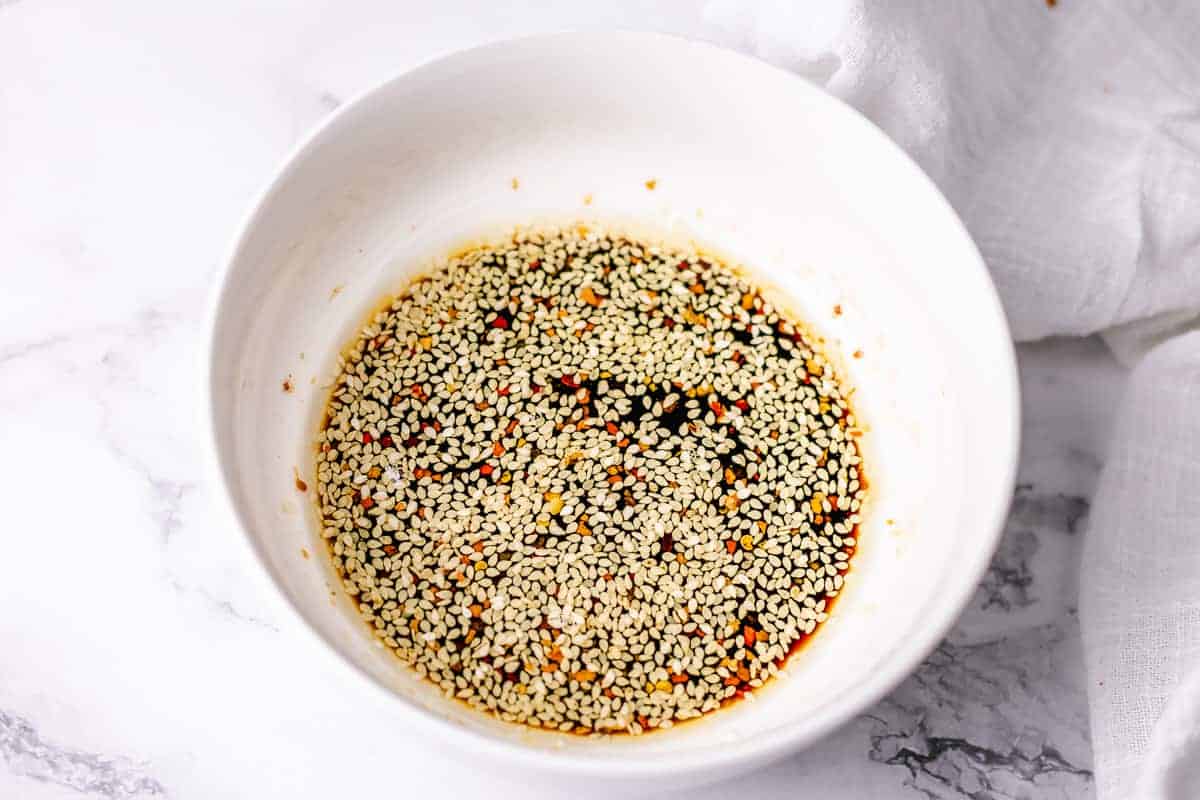 soba noodles stir fry sauce in a bowl with sesame seeds