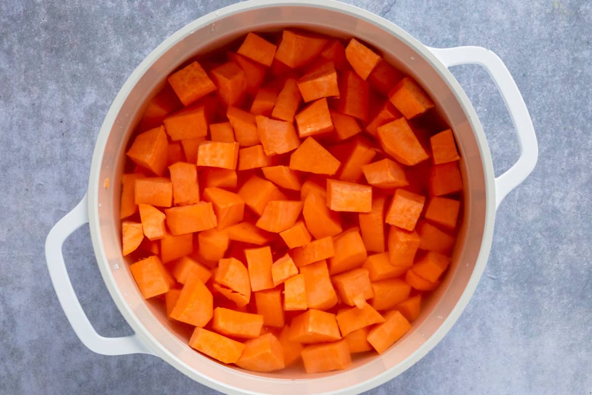 sweet potato chunks cooking in a pot with water