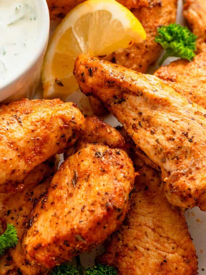 chicken tenders served with white dipping sauce.