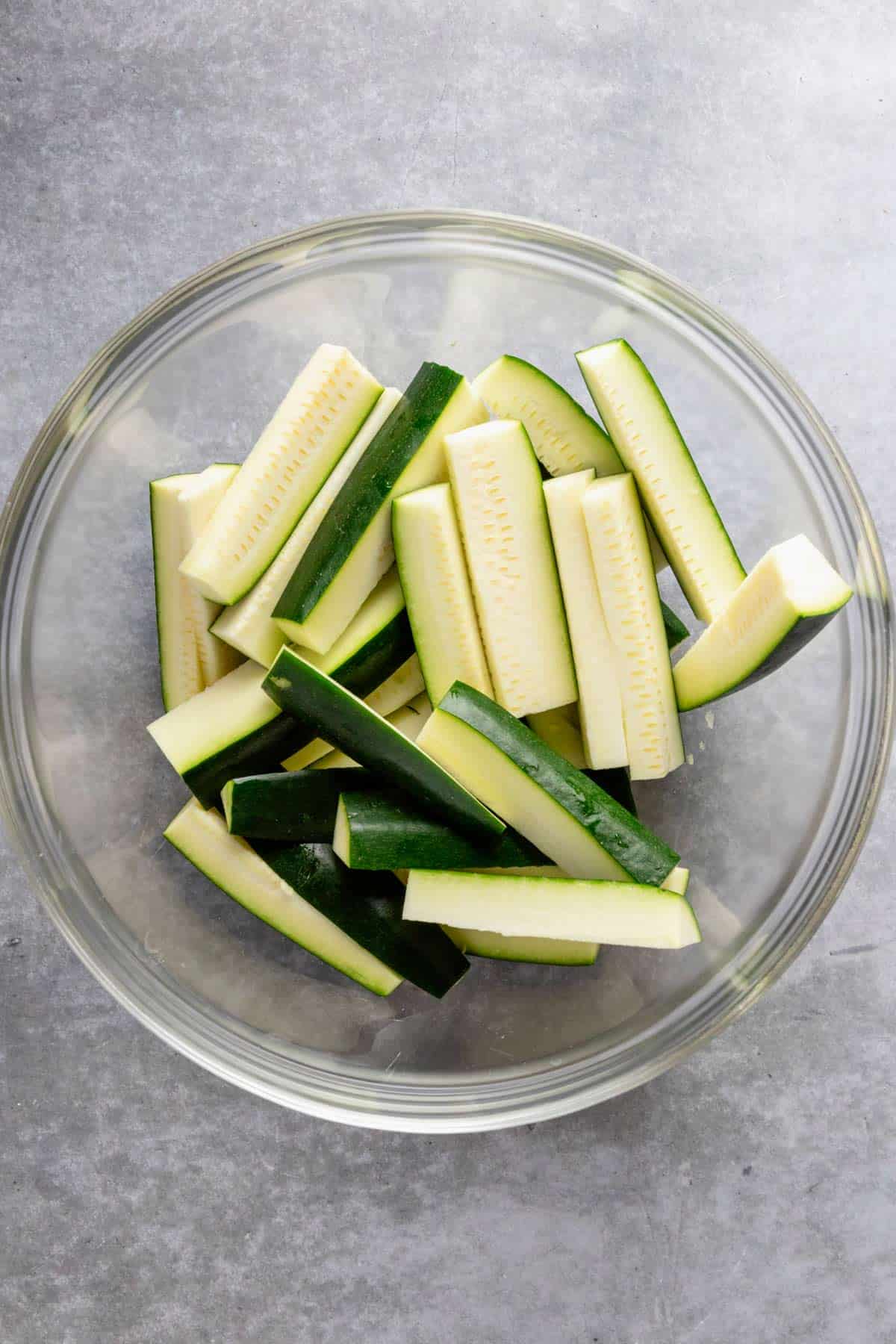 raw zucchini sticks in a bowl.