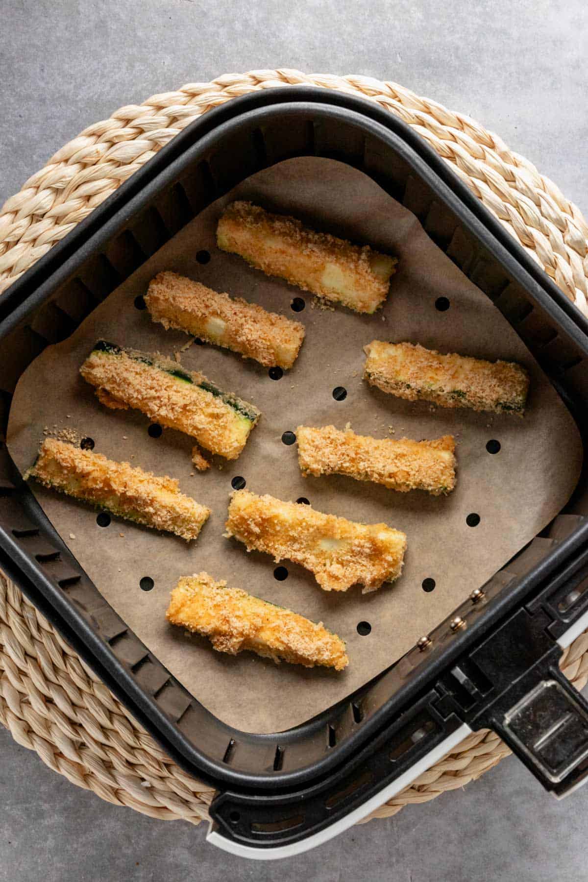 zucchini sticks in air fryer before cooking.