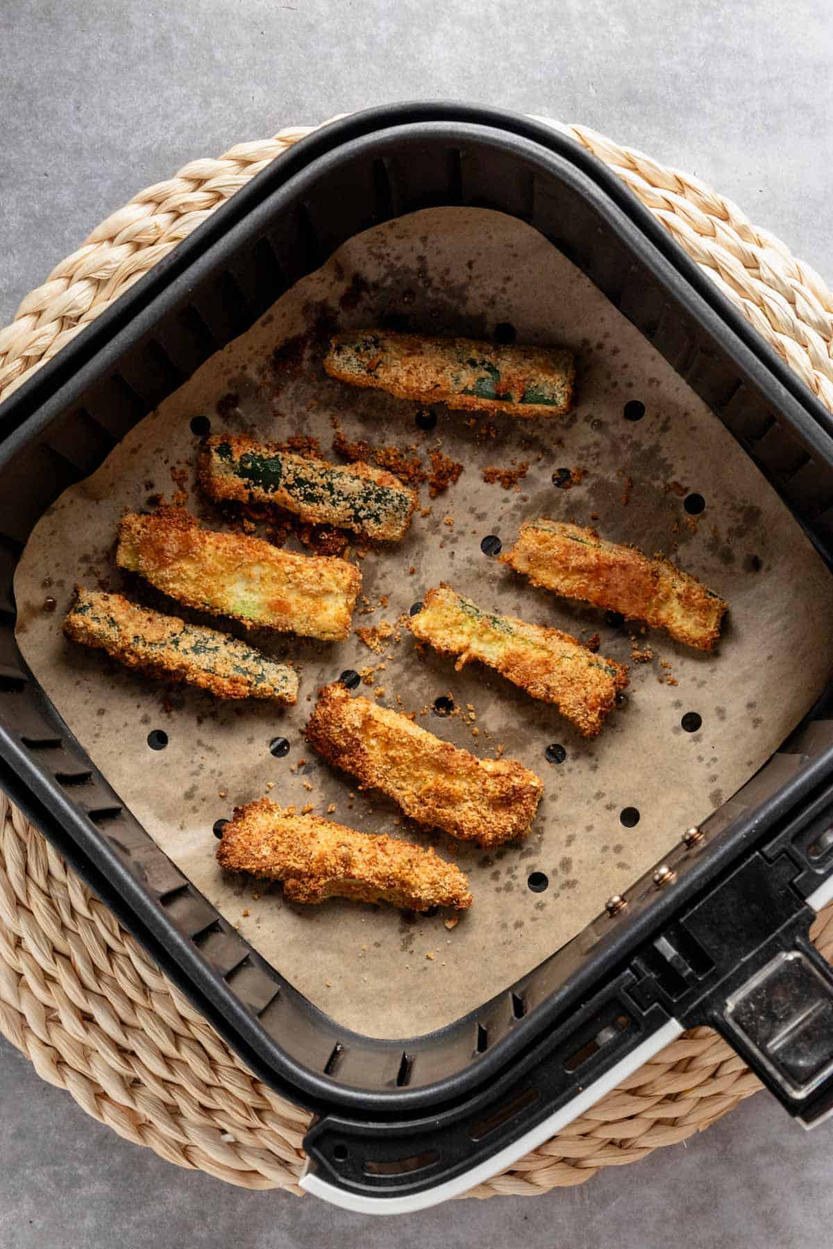 freshly roasted air fryer keto zucchini sticks in air fryer basket.