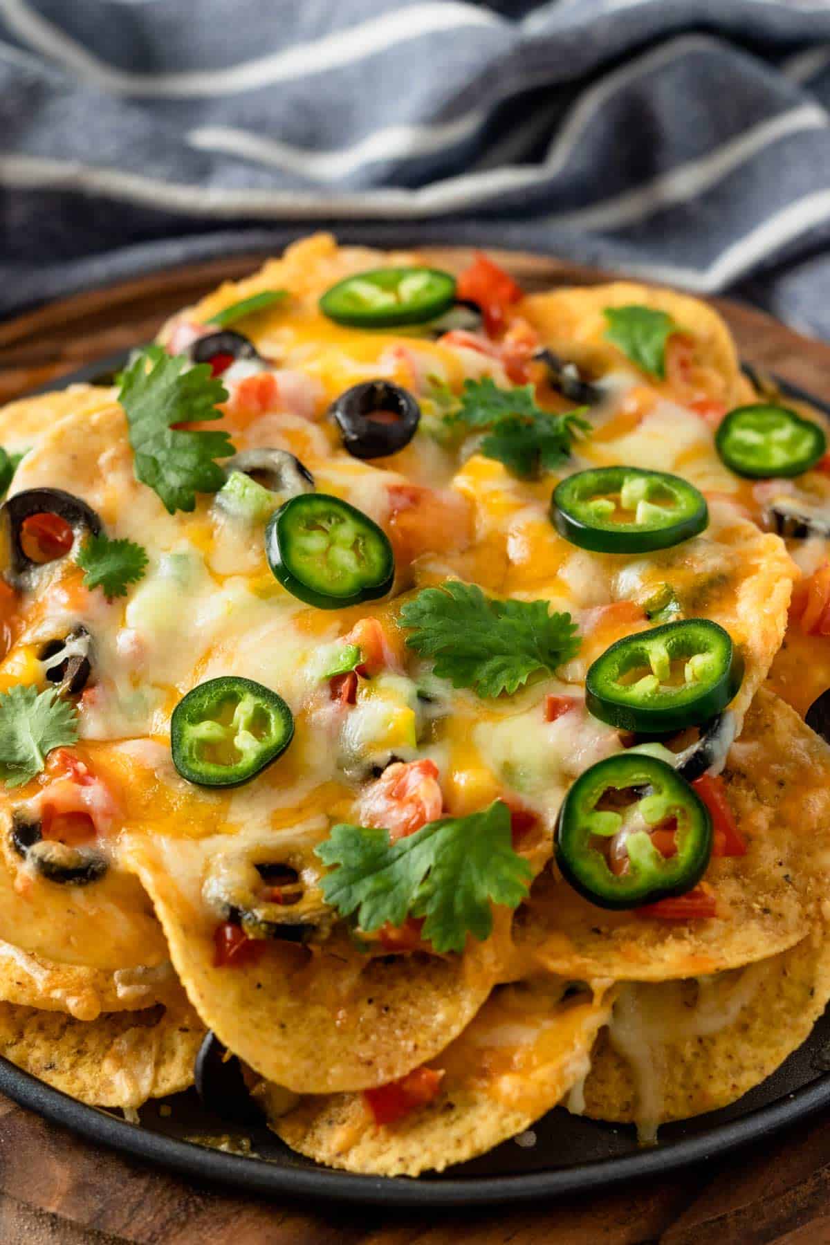 a stack of corn tortilla chips with toppings
