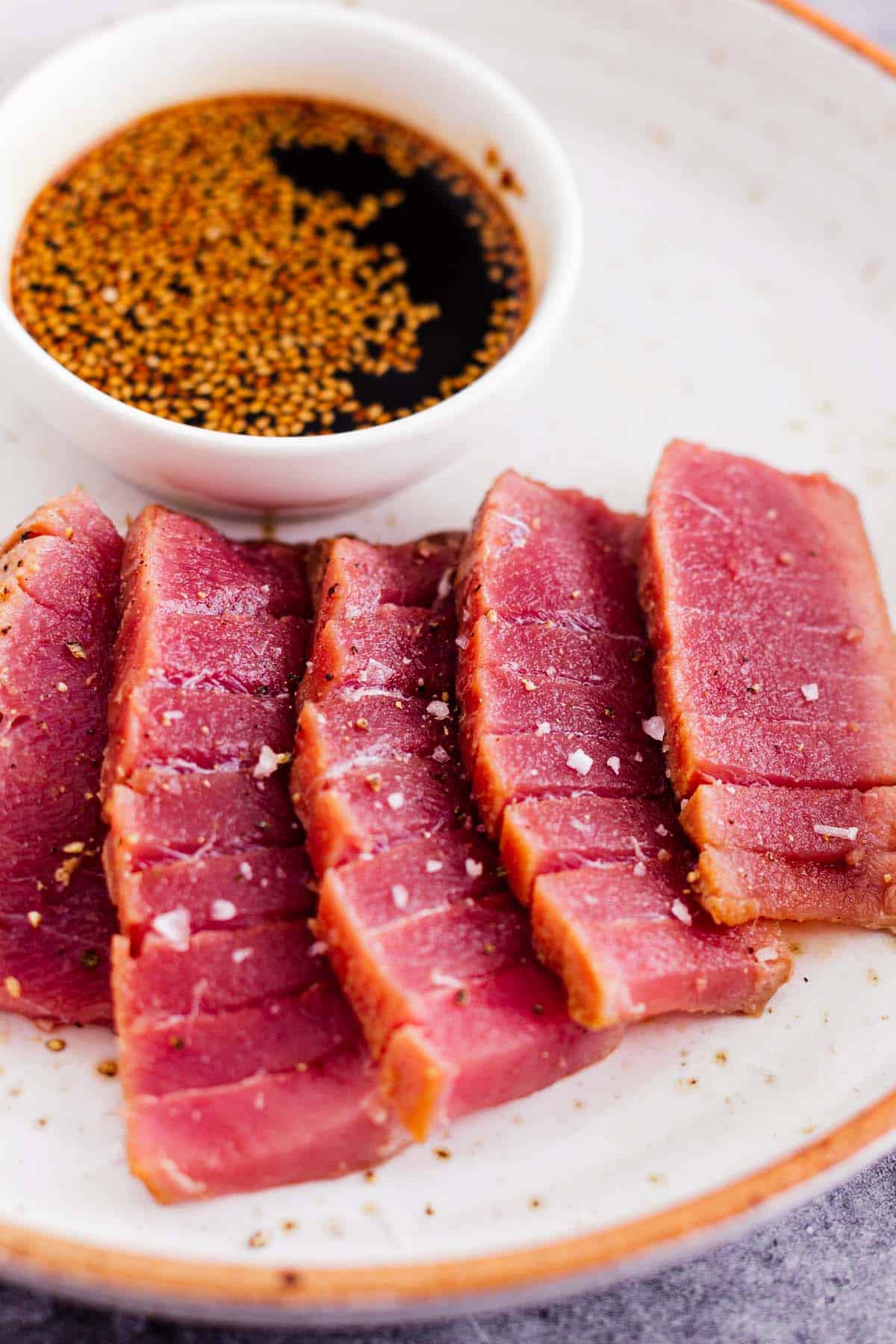 air fryer tuna steak cut into slices and drizzled with soy sauce