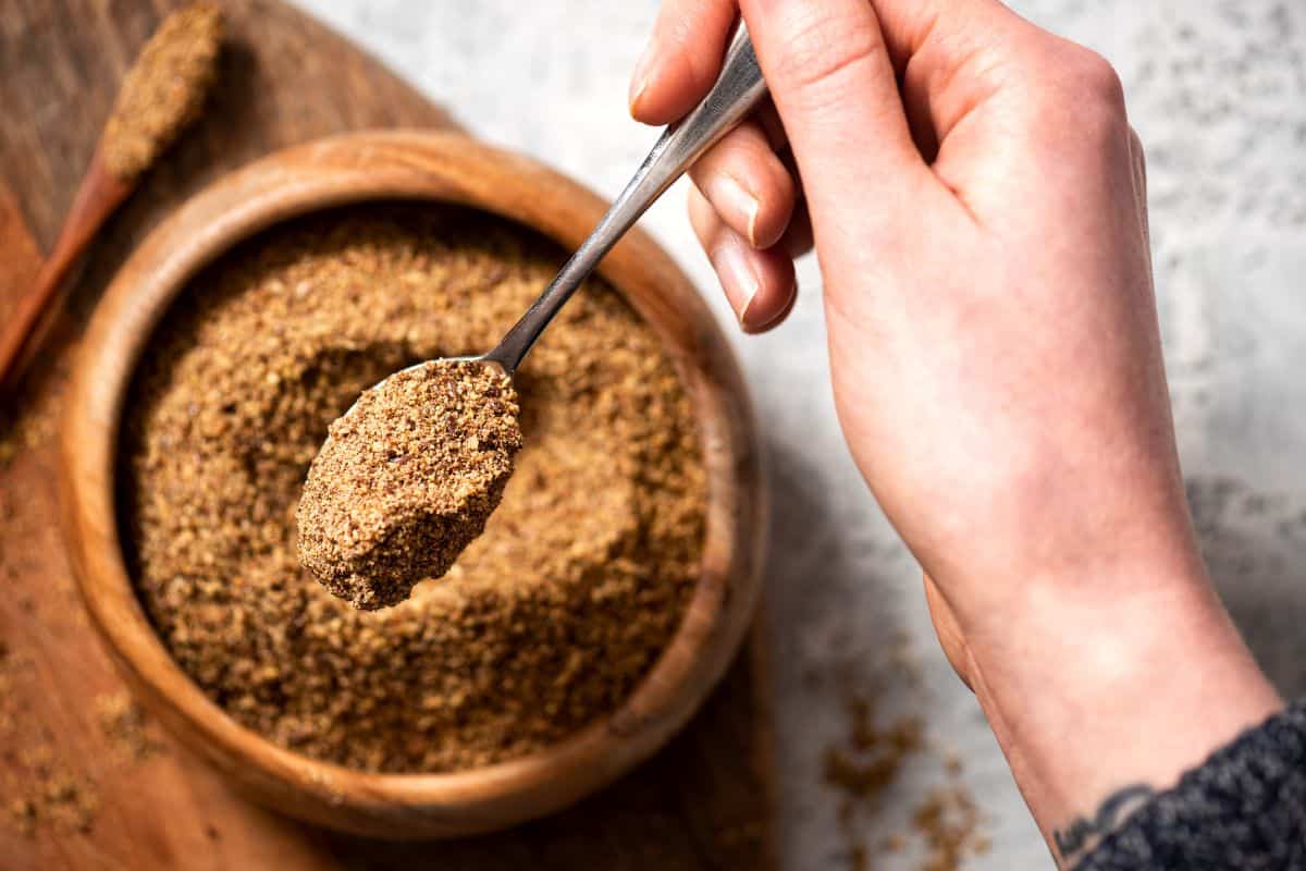 ground flaxseed flour in a bowl with a spoon.