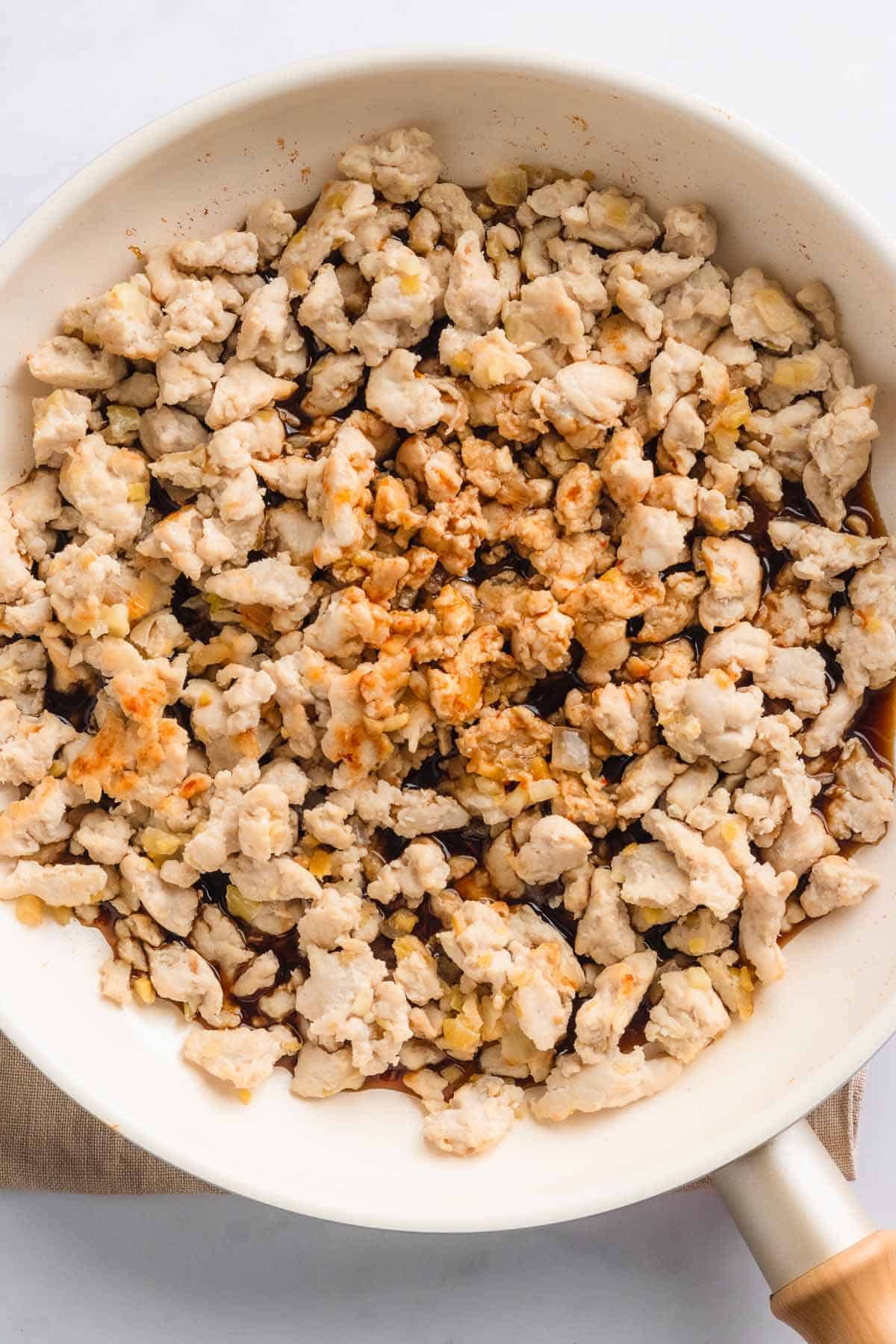 Plain cooked diced chicken on white plate.