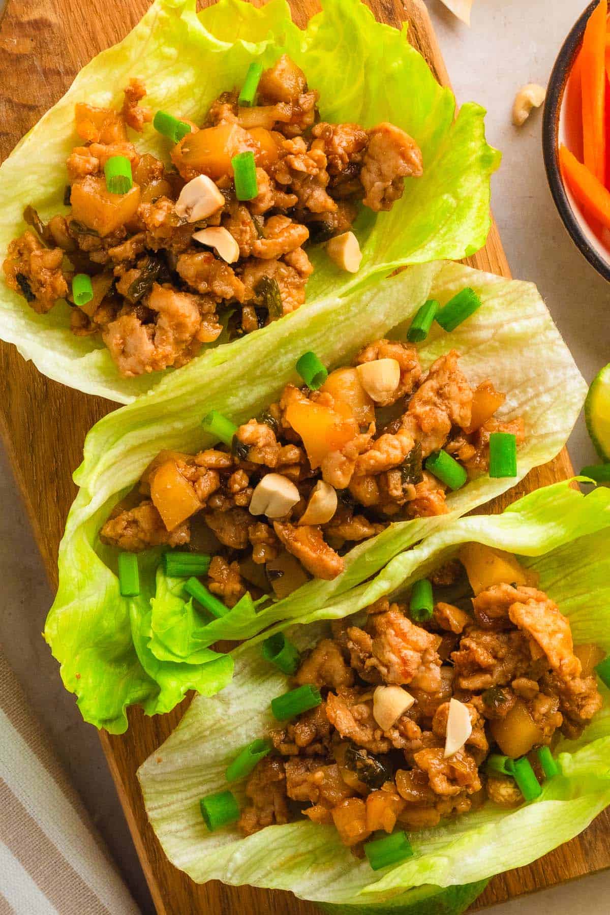 Fresh lettuce wraps filled with seasoned ground chicken and vegetables.