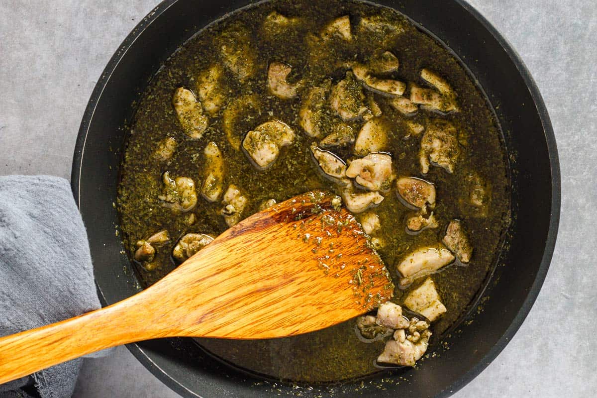 chicken cooking in pesto sauce