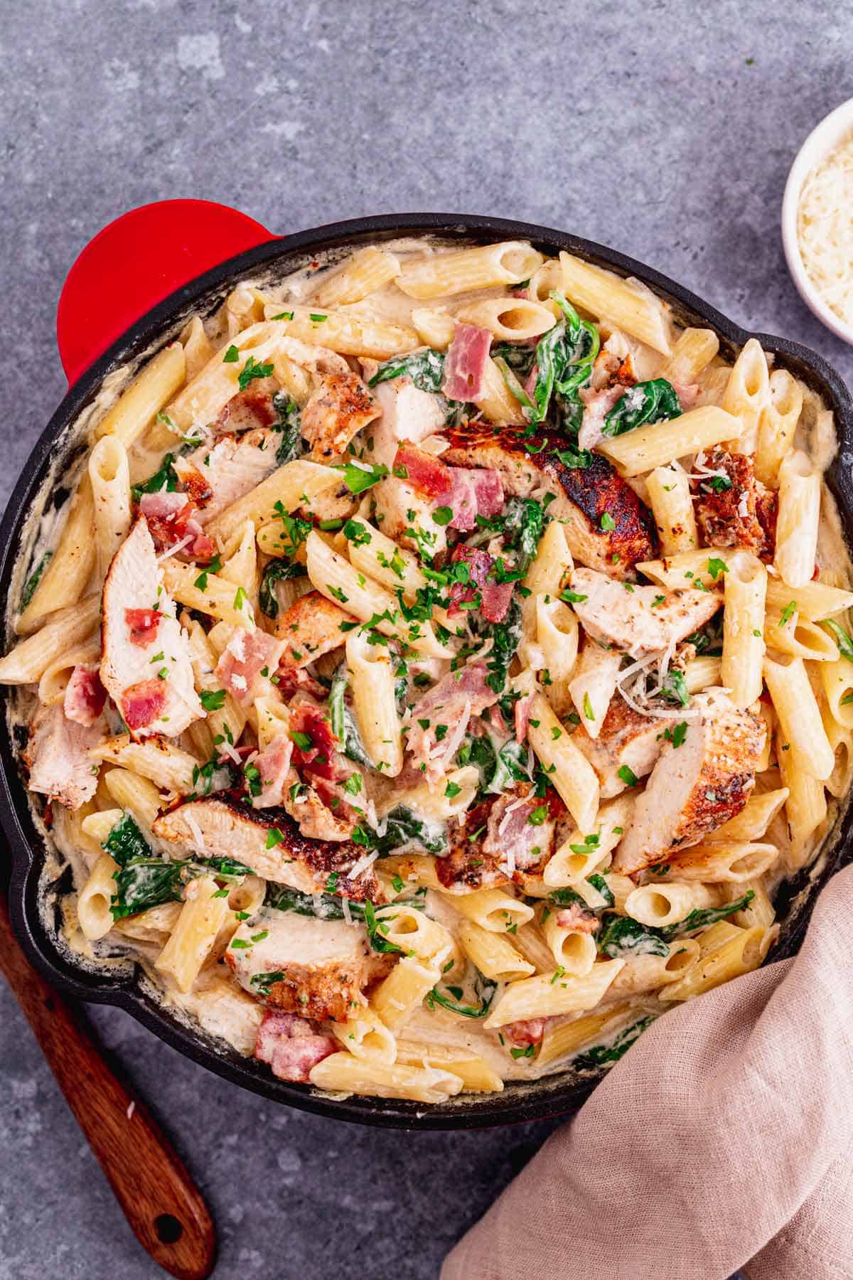 This Creamy Chicken Bacon And Spinach Pasta is one of our all-time favorite dinner recipes.  Tender juicy chicken over pasta in a rich creamy sauce with spinach and bacon. An excellent easy weeknight or weekend dinner recipe for the whole family. Yum! - The Yummy Bowl
