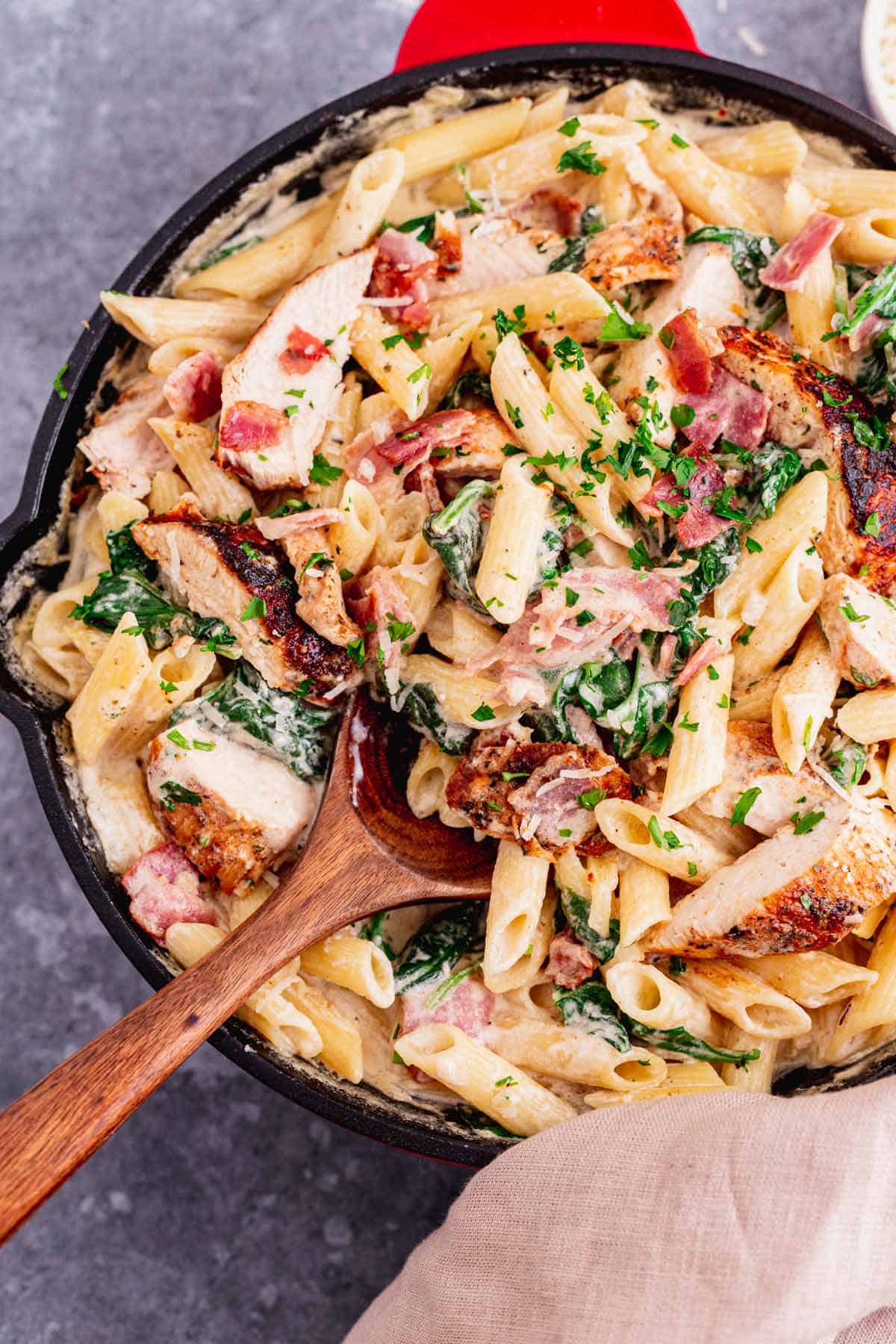 This Creamy Chicken Bacon And Spinach Pasta is one of our all-time favorite dinner recipes. Tender juicy chicken over pasta in a rich creamy sauce with spinach and bacon. An excellent easy weeknight or weekend dinner recipe for the whole family. Yum! - The Yummy Bowl