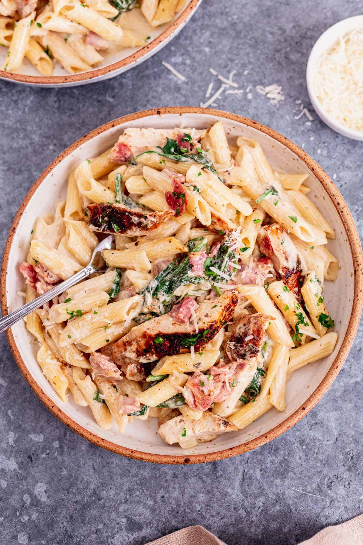 This Creamy Chicken Bacon And Spinach Pasta is one of our all-time favorite dinner recipes. Tender juicy chicken over pasta in a rich creamy sauce with spinach and bacon. An excellent easy weeknight or weekend dinner recipe for the whole family. Yum! - The Yummy Bowl