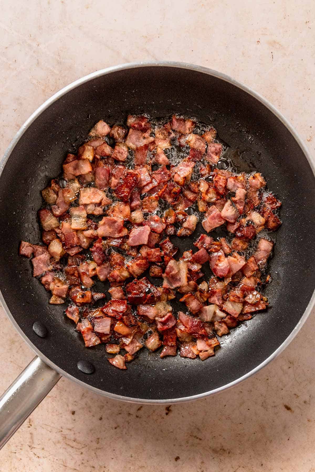 bacon bits frying in a pan