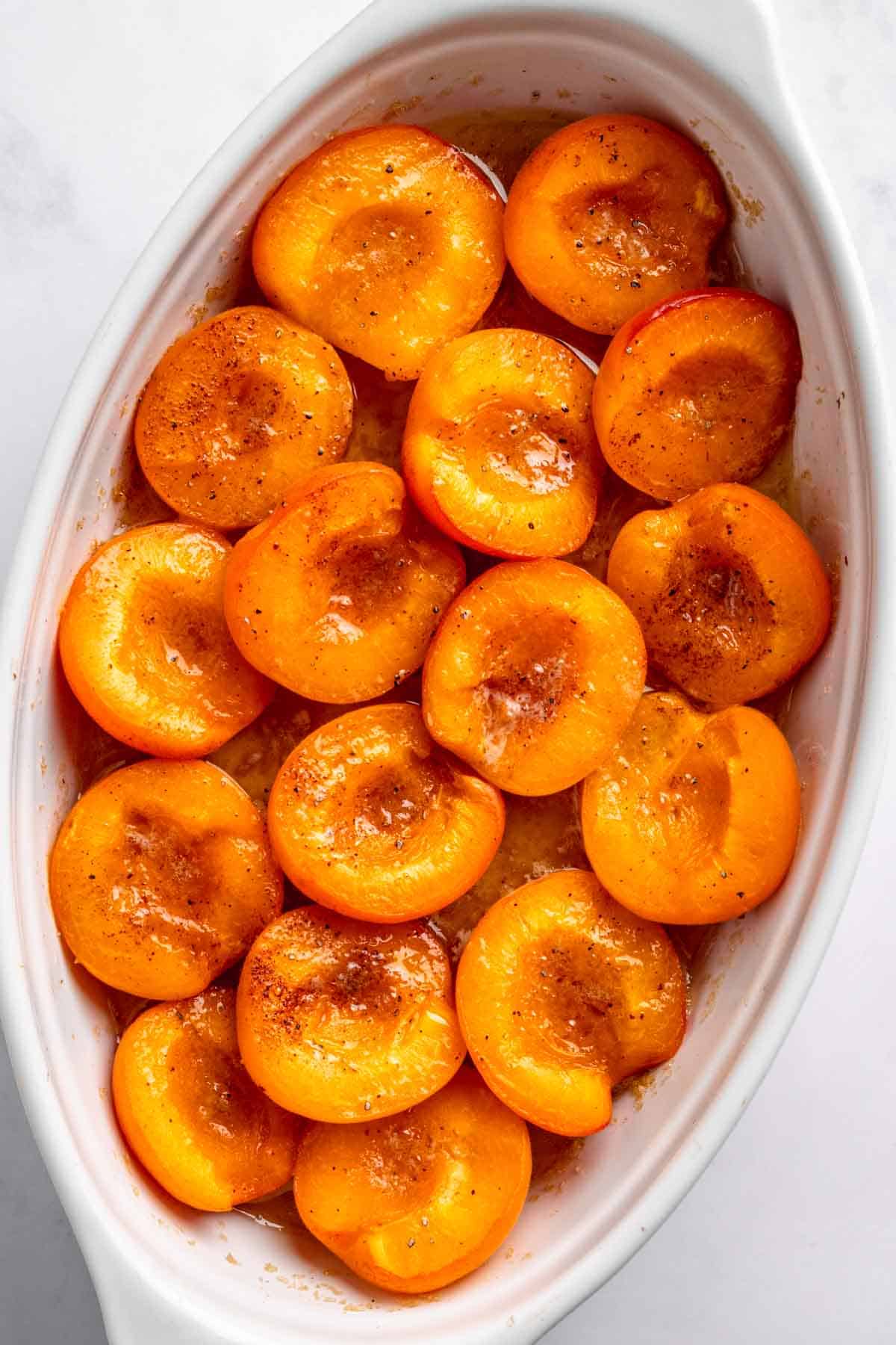 Apricots in baking dish with butter.
