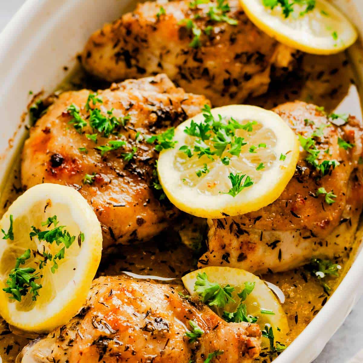 greek lemon chicken in baking dish.
