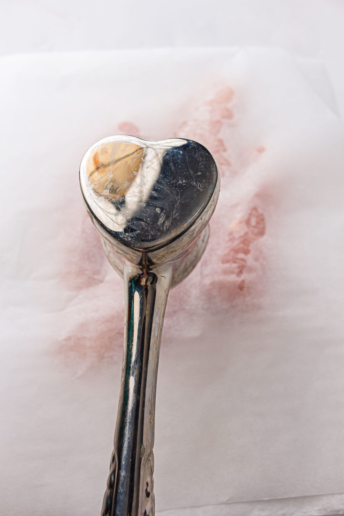 Pounding chicken breasts evenly before baking.